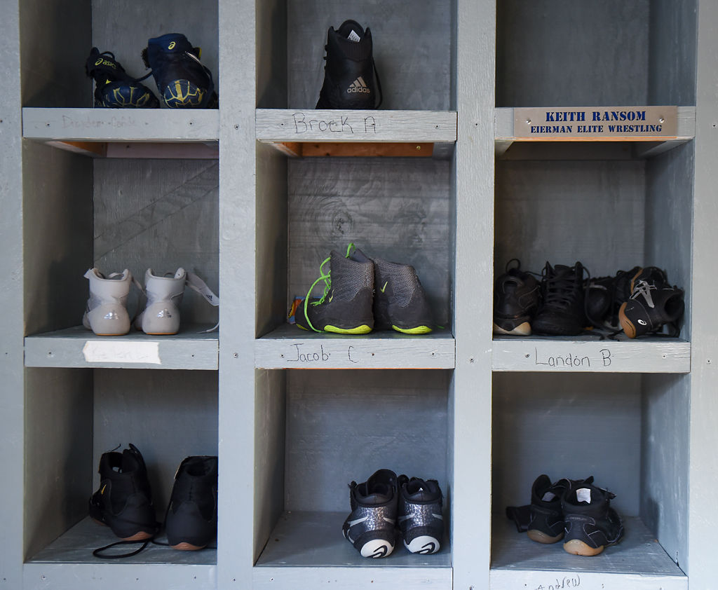 Wrestling shoes sit in cubbies